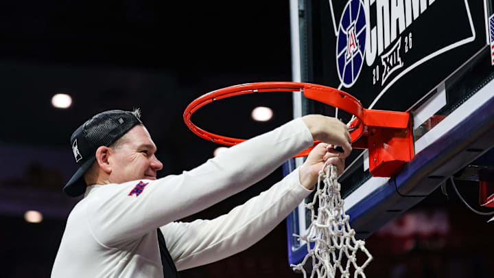 Mar 2, 2026; Tucson, Arizona, USA; Arizona Wildcats head coach Tommy Lloyd cuts down the net after they defeat the Iowa State Cyclones   at McKale Memorial Center. Mandatory Credit: Aryanna Frank-Imagn Images