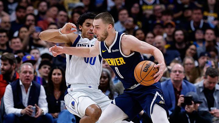 Mar 25, 2026; Denver, Colorado, USA; Denver Nuggets guard Christian Braun (0) controls the ball as Dallas Mavericks guard Max Christie (00) defends in the third quarter at Ball Arena. Mandatory Credit: Isaiah J. Downing-Imagn Images
