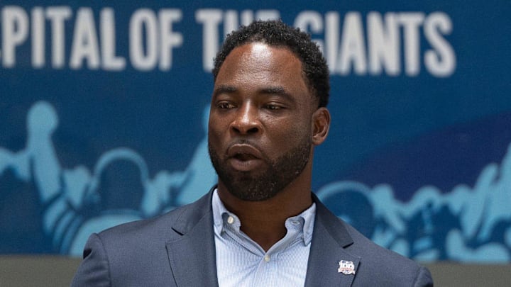 Former Giants player Justin Tuck speaks during a ceremony to unveil a mural