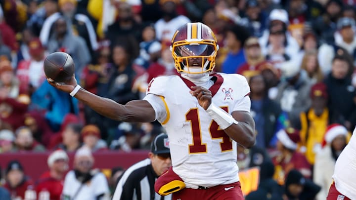 Dec 25, 2025; Landover, Maryland, USA; Washington Commanders quarterback Josh Johnson (14) passes the ball against the Dallas Cowboys in the first half at Northwest Stadium. Mandatory Credit: Amber Searls-Imagn Images