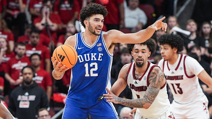Duke Blue Devils forward Cameron Boozer (12) directs a play as Louisville Cardinals guard J'vonne Hadley (1) guards during a conference ACC game. January 6, 2026. Duke Blue Devils forward Cameron Boozer (12) directs a play as Louisville Cardinals guard J'vonne Hadley (1) guards during a conference ACC game. January 6, 2026.
