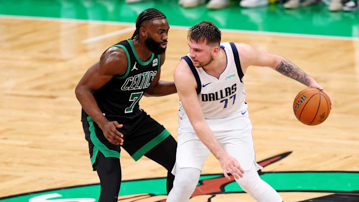 Jun 9, 2024; Boston, Massachusetts, USA; Dallas Mavericks guard Luka Doncic (77) handles the ball against Boston Celtics guard Jaylen Brown (7) during game two of the 2024 NBA Finals at TD Garden. Mandatory Credit: Peter Casey-Imagn Images