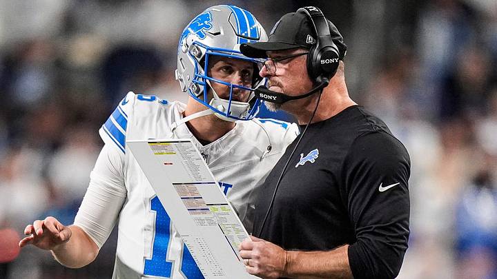 Detroit Lions quarterback Jared Goff (16) talks to head coach Dan Campbell before a play against Dallas Cowboys during the second half at Ford Field in Detroit on Thursday, Dec. 4, 2025.