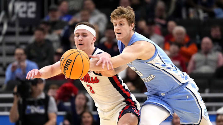 Mar 21, 2025; Milwaukee, WI, USA; Mississippi Rebels guard Sean Pedulla (3) and North Carolina Tar Heels guard Cade Tyson (5) chase a loose ball during the first half of a first round NCAA men’s tournament game at Fiserv Forum. Mandatory Credit: Jeff Hanisch-Imagn Images