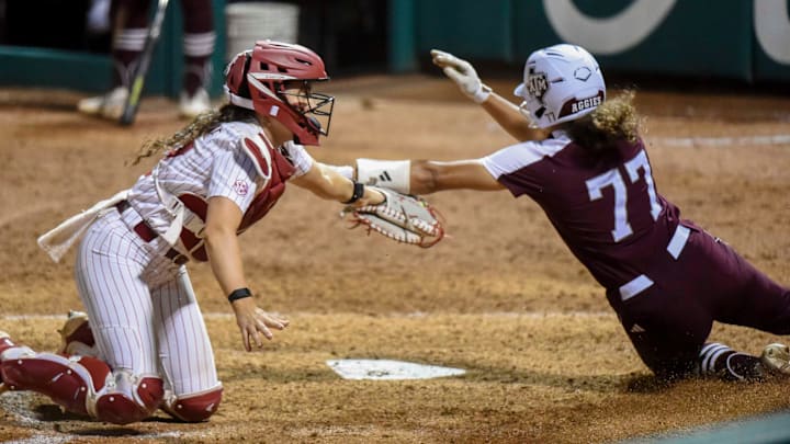 April 15, 2024; Tuscaloosa, AL, USA; Alabama catcher Riley Valentine (17) takes a throw and makes a tag to put out Texas A&M base runner Jazmine Hill at the plate at Rhoads Stadium Monday.