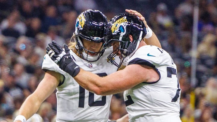 Aug 17, 2025; New Orleans, Louisiana, USA;  Jacksonville Jaguars quarterback Trevor Lawrence (16) and offensive tackle Walker Little (72) celebrate a touchdown against the New Orleans Saints during the first half at Caesars Superdome. Mandatory Credit: Stephen Lew-Imagn Images