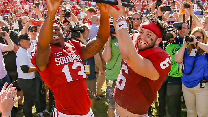Oklahoma's Ahmad Thomas (13) and Baker Mayfield (6) hold up the Golden Hat trophy after the Red River Showdown college football game between the University of Oklahoma Sooners (OU) and the Texas Longhorns (UT) at Cotton Bowl Stadium in Dallas, Saturday, Oct. 8, 2016. Oklahoma won 45-40.