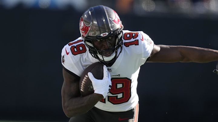 Jan 7, 2024; Charlotte, North Carolina, USA; Tampa Bay Buccaneers wide receiver Rakim Jarrett (18) rushes the ball against Carolina Panthers linebacker Deion Jones (40) during the second quarter at Bank of America Stadium. Mandatory Credit: Jim Dedmon-Imagn Images