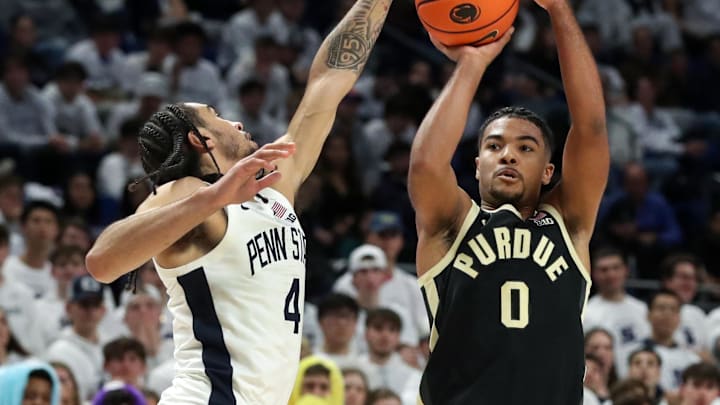 Purdue Boilermakers guard CJ Cox (0) shoots the ball as Penn State Nittany Lions guard Freddie Dilione V (4) defends Purdue Boilermakers guard CJ Cox (0) shoots the ball as Penn State Nittany Lions guard Freddie Dilione V (4) defends