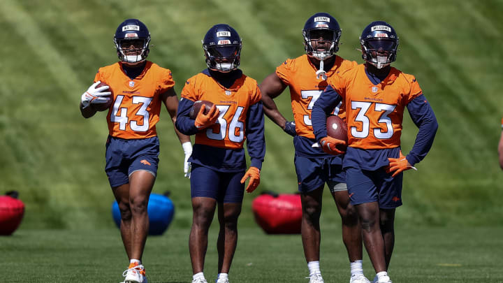 May 23, 2024; Englewood, CO, USA; Denver Broncos running back Blake Watson (43) and running back Tyler Badie (36) and running back Audric Estime (37) and running back Javonte Williams (33) look on as full back Michael Burton (20) runs a drill during organized team activities at Centura Health Training Center. May 23, 2024; Englewood, CO, USA; Denver Broncos running back Blake Watson (43) and running back Tyler Badie (36) and running back Audric Estime (37) and running back Javonte Williams (33) look on as full back Michael Burton (20) runs a drill during organized team activities at Centura Health Training Center.