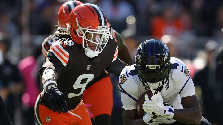 Oct 18, 2026; Cleveland, Ohio, USA;  Baltimore Ravens wide receiver Zay Flowers (4) runs the ball under pressure from Cleveland Browns safety Grant Delpit (9) in the first quarter at Huntington Bank Field.  Mandatory Credit: Scott Galvin-Imagn Images