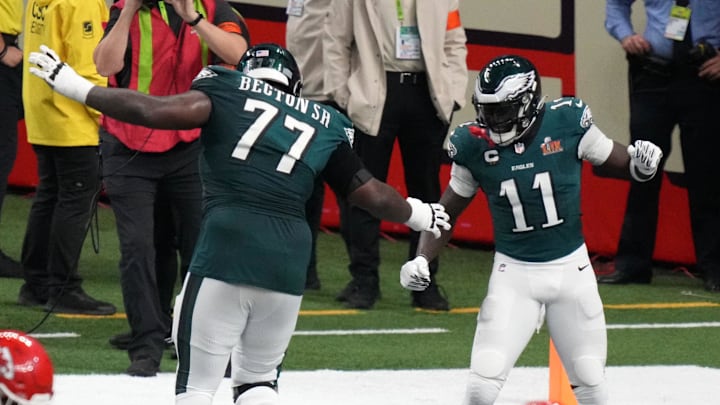 Philadelphia Eagles wide receiver A.J. Brown (11) reacts with offensive tackle Mekhi Becton (77) after touchdown drive