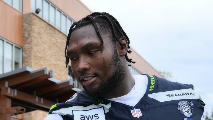 Seattle Seahawks offensive tackle Charles Cross interacts with fans after the first training camp. Seattle Seahawks offensive tackle Charles Cross interacts with fans after the first training camp.