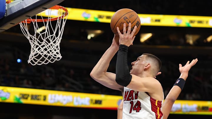 Dec 21, 2024; Orlando, Florida, USA; Miami Heat guard Tyler Herro (14) shoots the ball against the Orlando Magic in the first quarter at Kia Center. Mandatory Credit: Nathan Ray Seebeck-Imagn Images