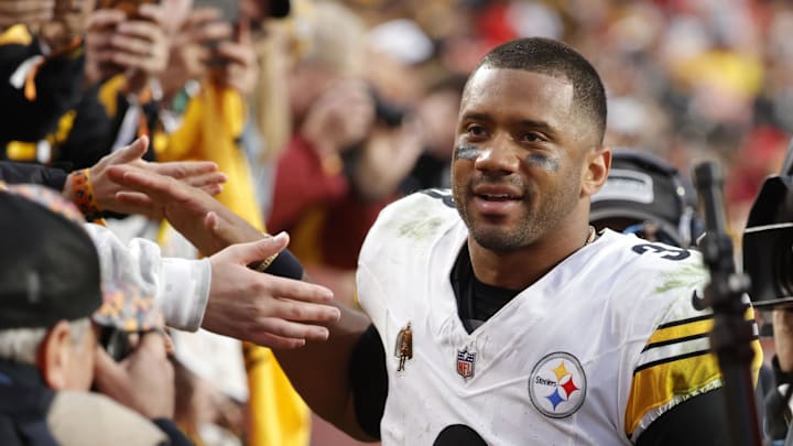 Pittsburgh Steelers quarterback Russell Wilson interacts with fans after a game.