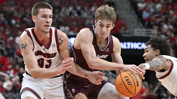 Nov 19, 2024; Louisville, Kentucky, USA;  Bellarmine Knights guard Billy Smith (11) looses control of the ball under the pressure of Louisville Cardinals forward Noah Waterman (93) and guard J'Vonne Hadley (1) during the first half at KFC Yum! Center. 