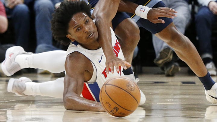 Nov 3, 2025; Memphis, Tennessee, USA; Detroit Pistons guard Ausar Thompson (9) and Memphis Grizzlies forward Jaylen Wells (0) dive for a loose ball during the first quarter at FedExForum.