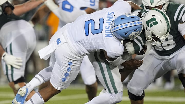 Sep 6, 2025; Charlotte, North Carolina, USA; Charlotte 49ers quarterback Conner Harrell (15) is tackled by North Carolina Tar Heels linebacker Andrew Simpson (2) for a sack during the second half at Jerry Richardson Stadium. Mandatory Credit: Jim Dedmon-Imagn Images