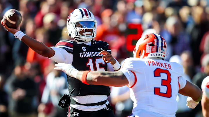 South Carolina Gamecocks quarterback Lanorris Sellers (16) passes under pressure from Clemson Tigers DE T.J. Parker (3) 