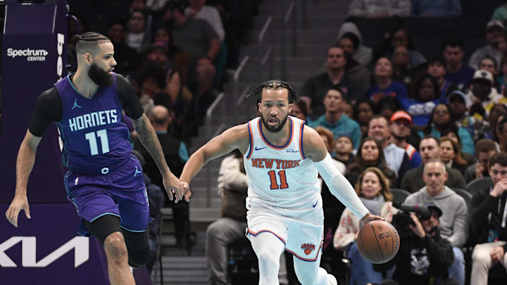 Nov 29, 2024; Charlotte, North Carolina, USA;  New York Knicks guard Jalen Brunson (11) drives past Charlotte Hornets guard Cody Martin (11) during the first half at the Spectrum Center. Mandatory Credit: Sam Sharpe-Imagn Images