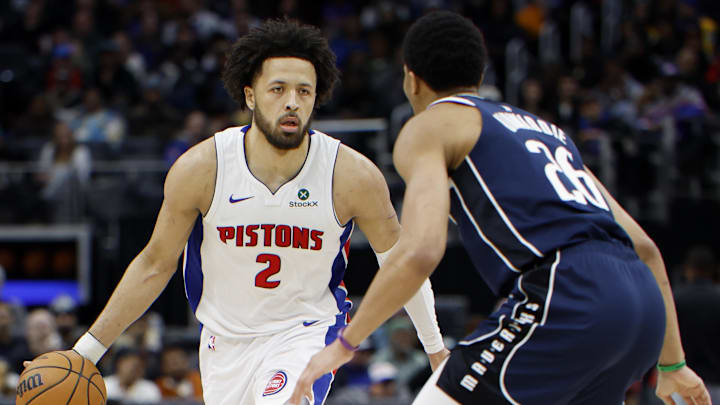 Jan 31, 2025; Detroit, Michigan, USA;  Detroit Pistons guard Cade Cunningham (2) dribbles defended by Dallas Mavericks guard Spencer Dinwiddie (26) in the second half at Little Caesars Arena. Mandatory Credit: Rick Osentoski-Imagn Images