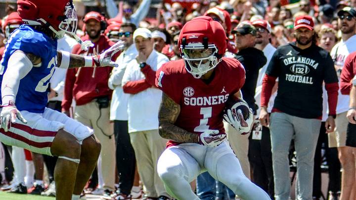 Oklahoma wide receiver Isaiah Sategna prepares to juke a defender in the spring game. Oklahoma wide receiver Isaiah Sategna prepares to juke a defender in the spring game.