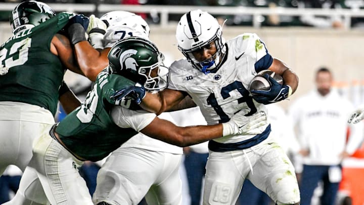 Michigan State's Wayne Matthews III, left, tackles Penn State's Kaytron Allen during the fourth quarter on Saturday, Nov. 15, 2025, at Spartan Stadium in East Lansing.