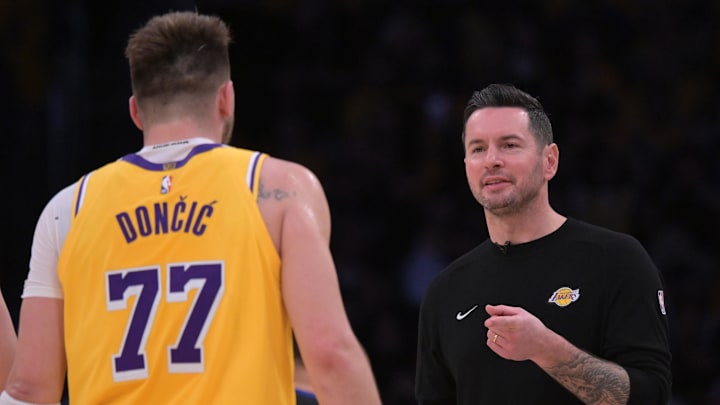 Feb 10, 2025; Los Angeles, California, USA; Los Angeles Lakers guard Luka Doncic (77) is greeted by head coach JJ Redick during a time out against the Utah Jazz at Crypto.com Arena. Mandatory Credit: Jayne Kamin-Oncea-Imagn Images