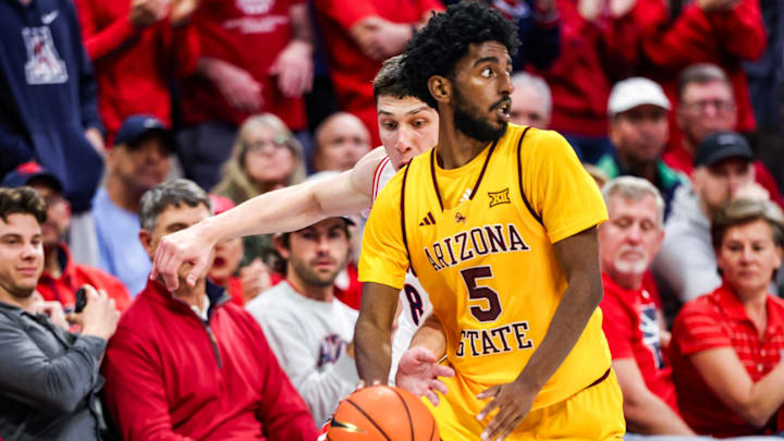 Jan 14, 2026; Tucson, Arizona, USA; Arizona Wildcats forward Ivan Kharchenkov (8) attempts to steal the ball from Arizona State Sun Devils guard Moe Odum (5) during the second half of the game at McKale Memorial Center. Mandatory Credit: Aryanna Frank-Imagn Images