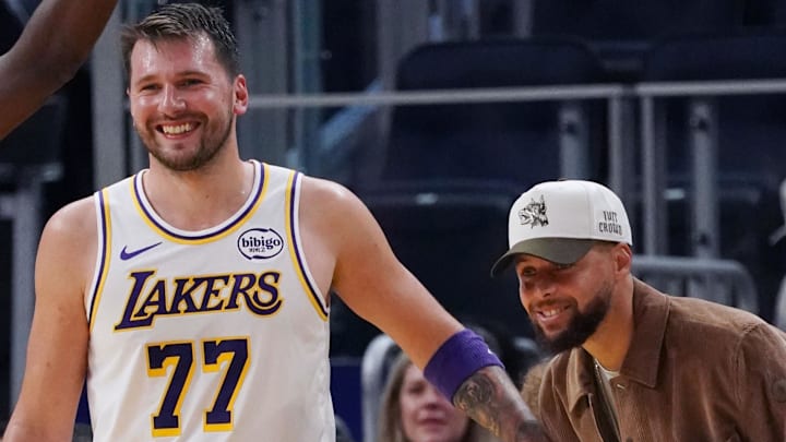 Feb 28, 2026; San Francisco, California, USA; Injured Golden State Warriors guard Stephen Curry (30) laughs with Los Angeles Lakers forward/guard Luka Doncic (77) in the third period at Chase Center. Mandatory Credit: David Gonzales-Imagn Images Feb 28, 2026; San Francisco, California, USA; Injured Golden State Warriors guard Stephen Curry (30) laughs with Los Angeles Lakers forward/guard Luka Doncic (77) in the third period at Chase Center. Mandatory Credit: David Gonzales-Imagn Images