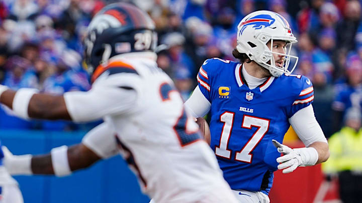 Buffalo Bills quarterback Josh Allen changes directions once he sees a receiver being closely followed and looks for another during the second half of the Buffalo Bills wild card game against the Denver Broncos.