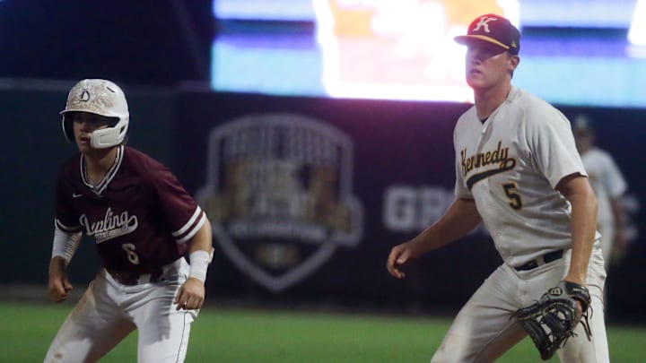 Dowling Catholic’s Jack Barrett (6) leads off as Cedar Rapids Kennedy’s Grant Mather (5) plays defense in the Class 4A Iowa high school state baseball championship Friday, July 26, 2024 at Veterans Memorial Stadium in Cedar Rapids, Iowa.