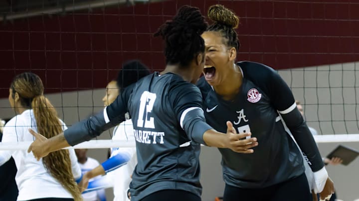Alabama Crimson Tide volleyball outside hitter Victoria Barrett and  middle blocker Sarah Stevens celebrate after a block against Memphis in the Crimson Classic. 