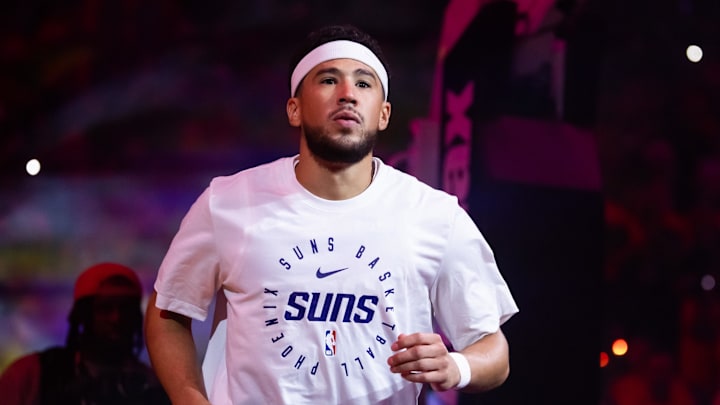 Oct 26, 2024; Phoenix, Arizona, USA; Phoenix Suns guard Devin Booker (1) against the Dallas Mavericks in the home opener at Footprint Center. Mandatory Credit: Mark J. Rebilas-Imagn Images