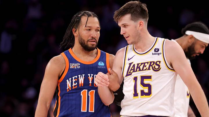 Feb 3, 2024; New York, New York, USA; New York Knicks guard Jalen Brunson (11) grabs Los Angeles Lakers guard Austin Reaves (15) during the fourth quarter at Madison Square Garden. Mandatory Credit: Brad Penner-Imagn Images