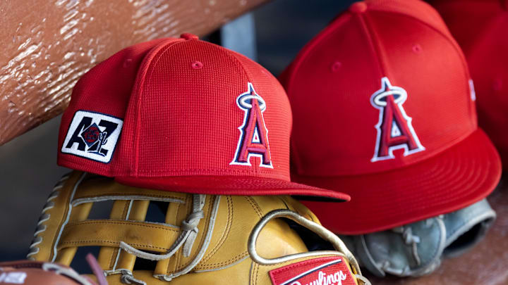 Feb 28, 2025; Phoenix, Arizona, USA; Detailed view of the Los Angeles Angels logo on a hat in the dugout during a spring training game at Camelback Ranch-Glendale. Mandatory Credit: Mark J. Rebilas-Imagn Images Feb 28, 2025; Phoenix, Arizona, USA; Detailed view of the Los Angeles Angels logo on a hat in the dugout during a spring training game at Camelback Ranch-Glendale. Mandatory Credit: Mark J. Rebilas-Imagn Images