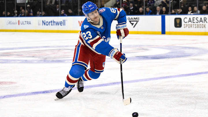 Nov 16, 2025; New York, New York, USA; New York Rangers defenseman Adam Fox (23) passes the puck against the Detroit Red Wings during the third period at Madison Square Garden. Mandatory Credit: John Jones-Imagn Images
