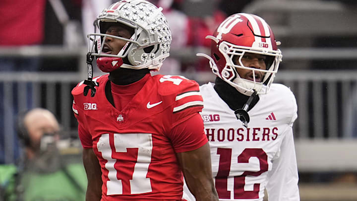 Ohio State Buckeyes wide receiver Carnell Tate (17) celebrates a first down catch beside Indiana Hoosiers defensive back Terry Jones Jr. (12) during the NCAA football game at Ohio Stadium in Columbus on Monday, Nov. 25, 2024. Ohio State won 38-15.