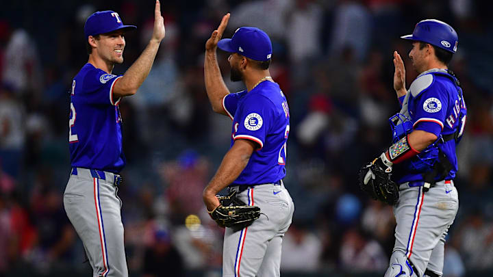 Jul 8, 2025; Anaheim, California, USA; Texas Rangers center fielder Evan Carter (32) shortstop Ezequiel Duran (20) and catcher Kyle Higashioka (11) celebrate the victory against the Los Angeles Angels at Angel Stadium
