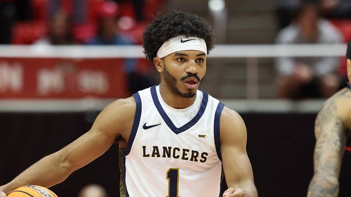 Dec 6, 2025; Salt Lake City, Utah, USA; California Baptist Lancers guard Dominique Daniels Jr. (1) brings the ball up the court against Utah Utes guard Terrence Brown (2) during the first half at Jon M. Huntsman Center. Mandatory Credit: Rob Gray-Imagn Images
