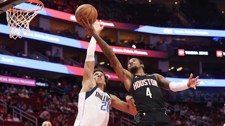 Mar 14, 2025; Houston, Texas, USA; Houston Rockets guard Jalen Green (4) shoots against Dallas Mavericks forward Kessler Edwards (20) in the first half at Toyota Center. Mandatory Credit: Thomas Shea-Imagn Images