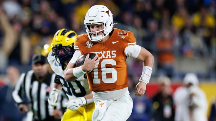 Texas Longhorns quarterback Arch Manning (16) rushes with the ball for a touchdown against the Michigan Wolverines during the second half at Camping World Stadium.