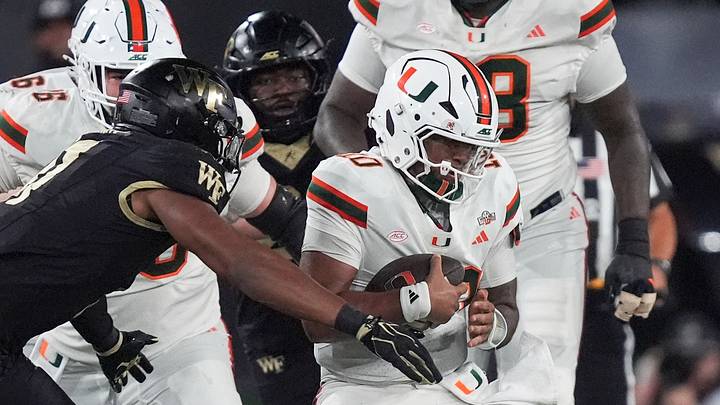 Sep 18, 2026; Winston-Salem, North Carolina, USA; Wake Forest Demon Deacons linebacker Langston Hardy (11) tackles Miami (FL) Hurricanes quarterback Darian Mensah (10) during the first half at Allegacy Federal Credit Union Stadium. Mandatory Credit: Jim Dedmon-Imagn Images Sep 18, 2026; Winston-Salem, North Carolina, USA; Wake Forest Demon Deacons linebacker Langston Hardy (11) tackles Miami (FL) Hurricanes quarterback Darian Mensah (10) during the first half at Allegacy Federal Credit Union Stadium. Mandatory Credit: Jim Dedmon-Imagn Images