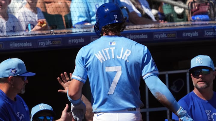 Mar 11, 2024; Surprise, Arizona, USA; Kansas City Royals shortstop Bobby Witt Jr. (7) returns to the dugout after scoring a run against the San Francisco Giants during the first inning at Surprise Stadium. Mandatory Credit: Joe Camporeale-Imagn Images