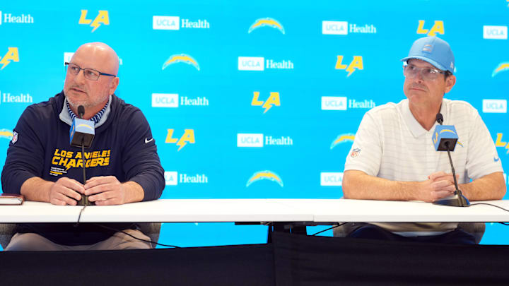 Jan 15, 2026; El Segundo, CA, USA; Los Angeles Chargers general manager Joe Hortiz (left) and coach Jim Harbaugh at press conference at The Bolt. Mandatory Credit: Kirby Lee-Imagn Images