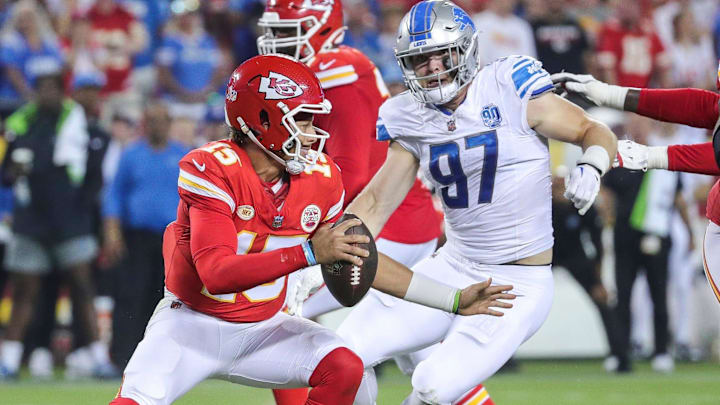 Detroit Lions defensive end Aidan Hutchinson (97) looks to tackle Kansas City Chiefs quarterback Patrick Mahomes (15) 