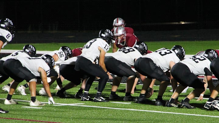 Darlington quarterback Zeke Zuberbuhler (13) prepares to take the snap in a season-opening non-conference game at  Platteville on Aug. 22, 2025.
