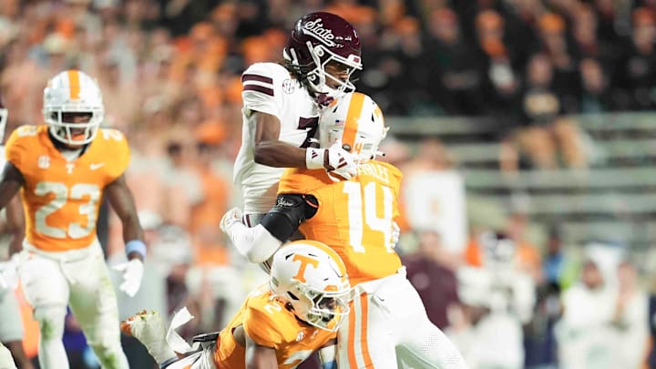 Tennessee Volunteers defensive back Andre Turrentine (2) and defensive back Christian Charles (14) try to take down Mississippi State Bulldogs wide receiver Mario Craver (7)  during the first half at Neyland Stadium.