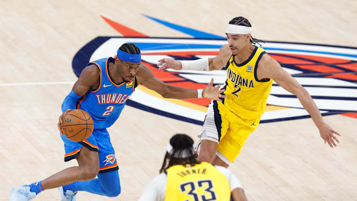Jun 22, 2025; Oklahoma City, Oklahoma, USA; Oklahoma City Thunder guard Shai Gilgeous-Alexander (2) dribbles the ball against Indiana Pacers guard Andrew Nembhard (2) during the first half of game seven of the 2025 NBA Finals at Paycom Center. Mandatory Credit: Alonzo Adams-Imagn Images