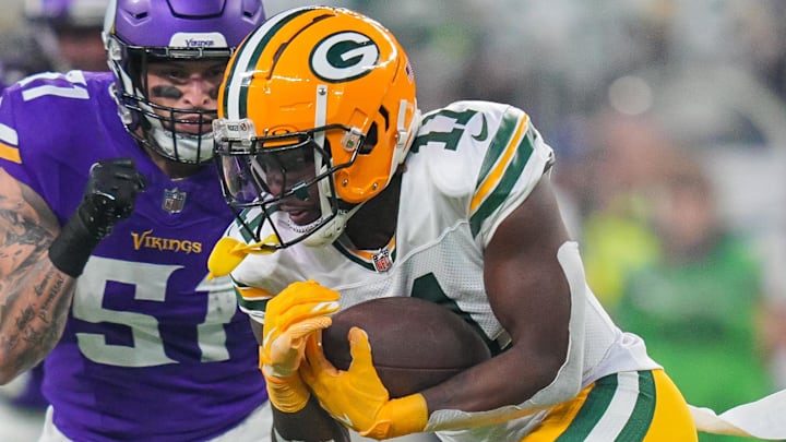 Dec 29, 2024; Minneapolis, Minnesota, USA; Green Bay Packers wide receiver Jayden Reed (11) runs after the catch against Minnesota Vikings linebacker Blake Cashman (51) in the second quarter at U.S. Bank Stadium. Mandatory Credit: Brad Rempel-Imagn Images